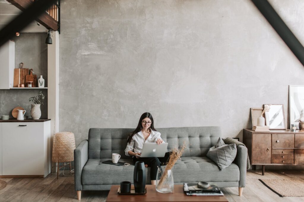 girl on couch looking at laptop